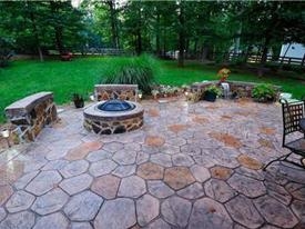 Fireplace and backyard with huge stamped concrete patio