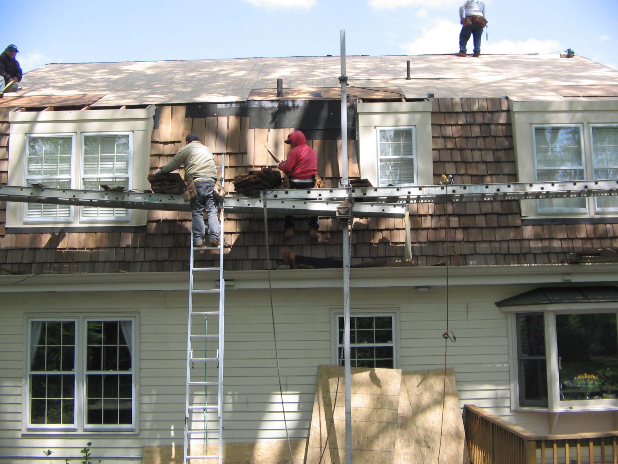 Roof being worked on and front of home