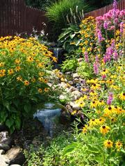 Beautiful Annuals & Perennials provide season long color from a TJB-INC design.