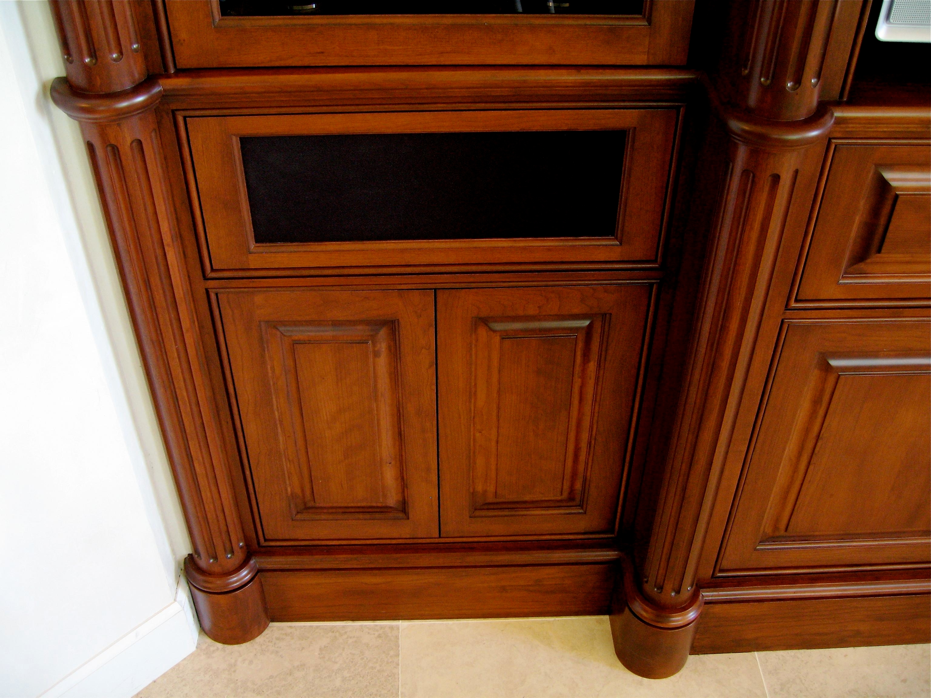 Detail view of fluted round columns, plinths and speaker panel.