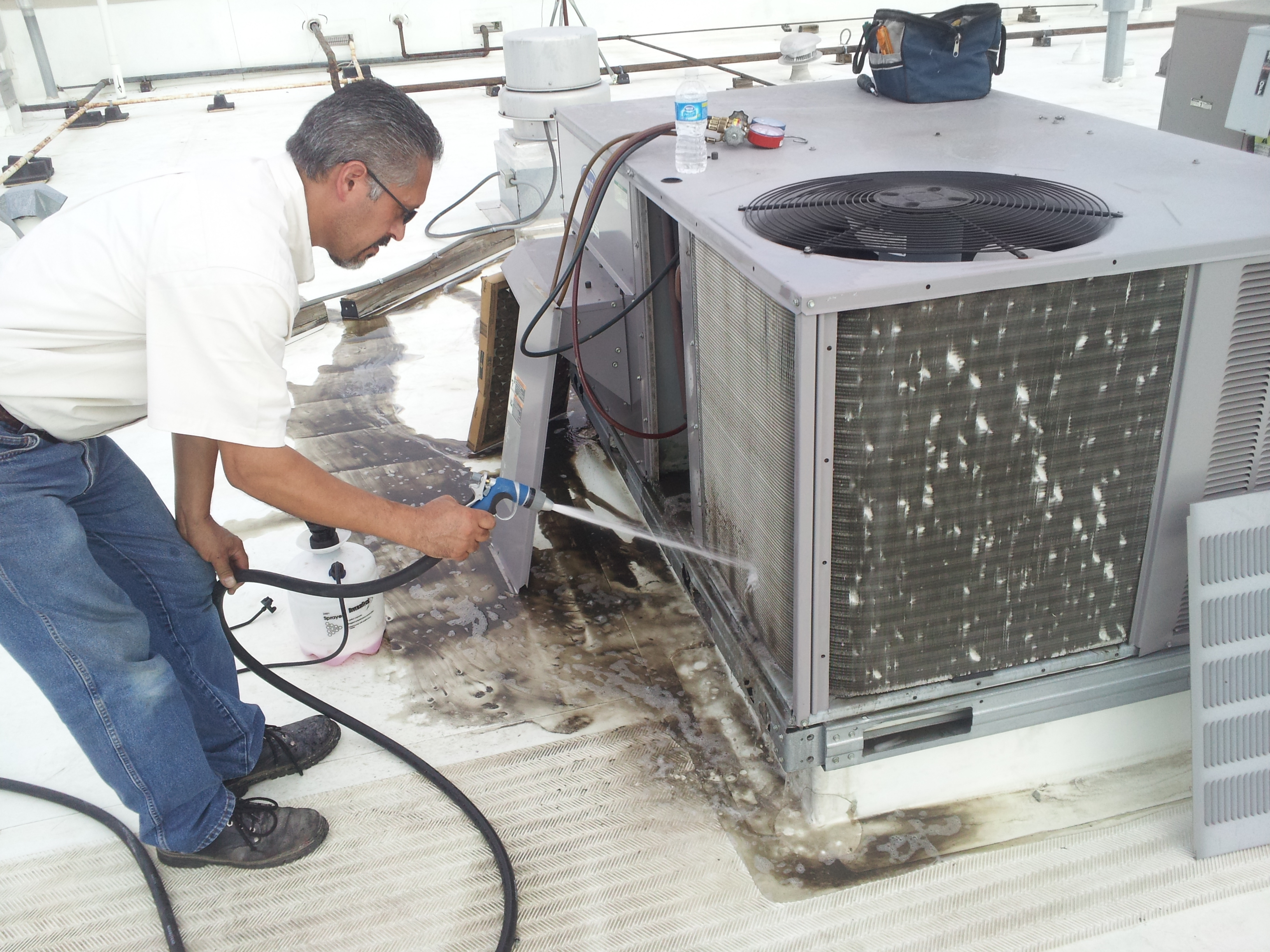 Air Zone Technician performing a spring cleaning in Austin, Tx, 2011