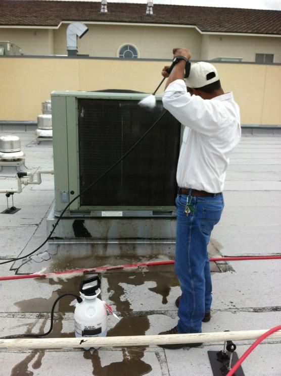 Air Zone Technician washing 14 commecial condenser coils. Austin, Tx, 2012